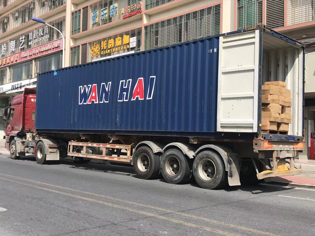 Export cartons being loaded into a shipping container